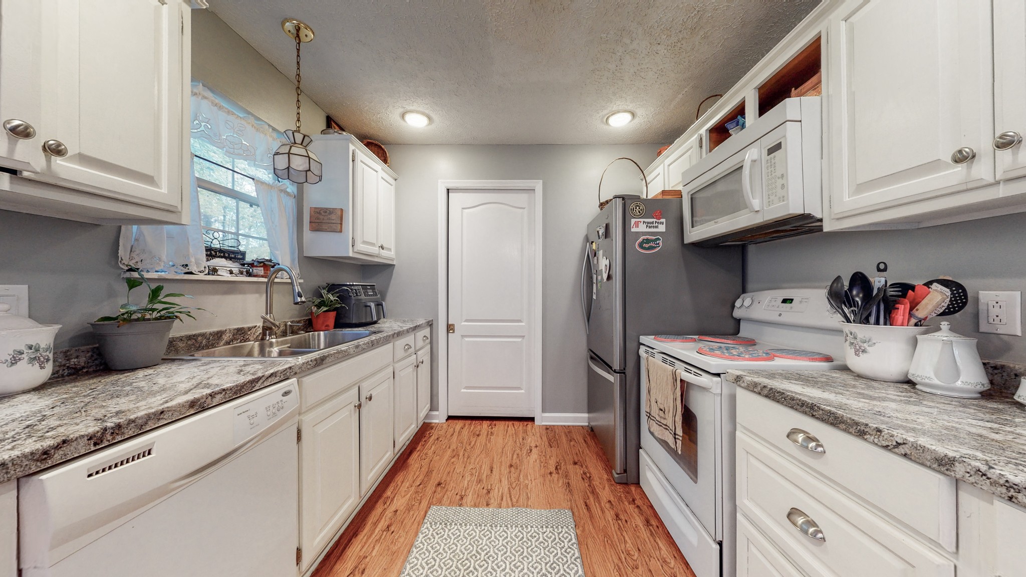 1081 Meeks Cemetery Road Burns, TN 37029 - Photo 19 of 45 a kitchen with stainless steel appliances granite countertop a sink and cabinets