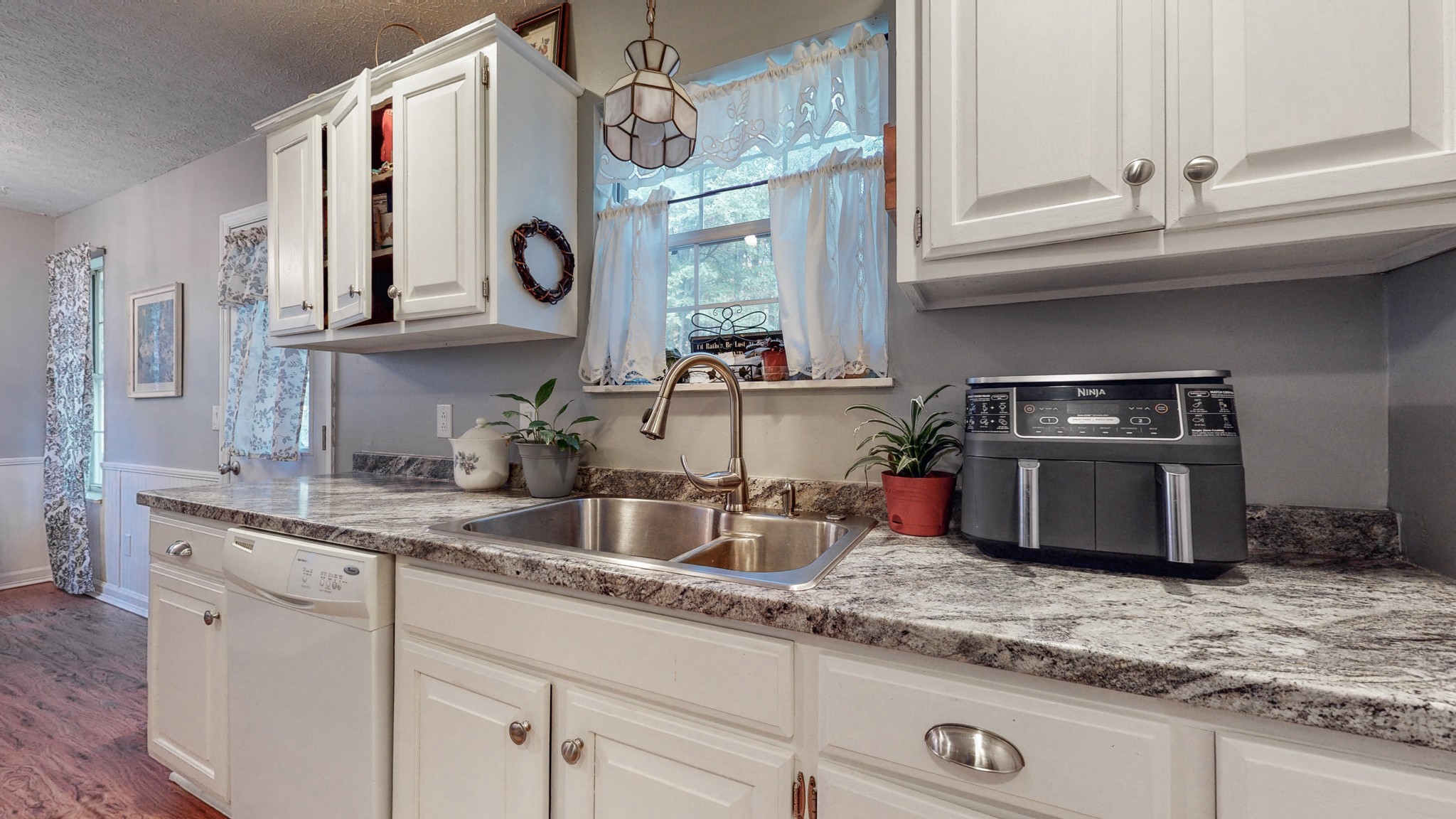 1081 Meeks Cemetery Road Burns, TN 37029 - Photo 20 of 45 a kitchen with kitchen island granite countertop a sink and a stove