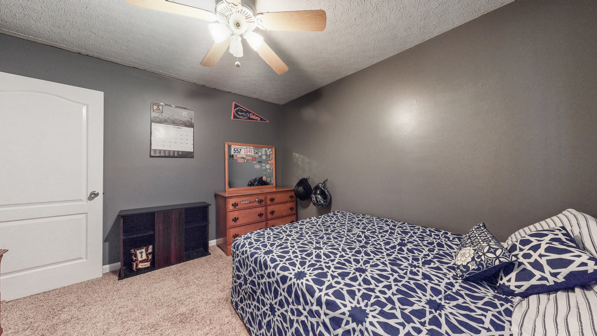 1081 Meeks Cemetery Road Burns, TN 37029 - Photo 34 of 45 a bedroom with a bed and a chandelier