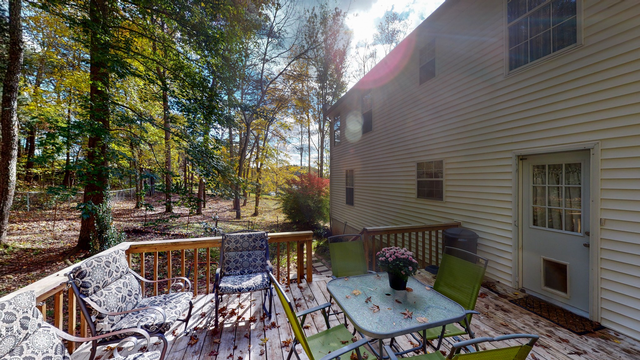 1081 Meeks Cemetery Road Burns, TN 37029 - Photo 10 of 45 a view of a patio with table and chairs with wooden floor and fence