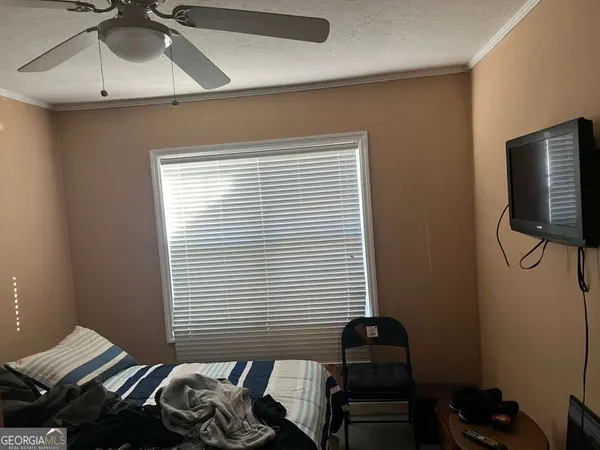 a bedroom with a bed and a window