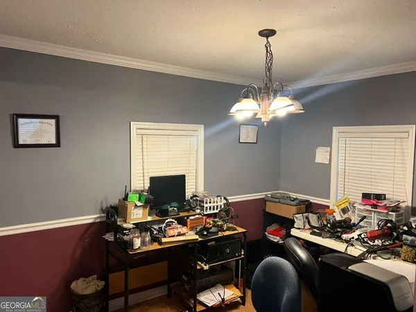 a room with furniture a chandelier and a window