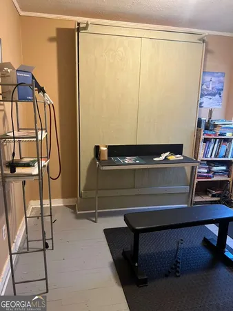 a room with a table chair and white walls