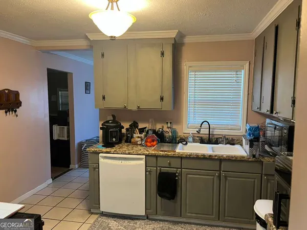 a kitchen with a sink stove and refrigerator