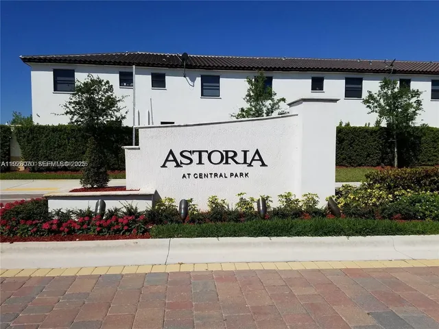 a view of a house with a yard and potted plants