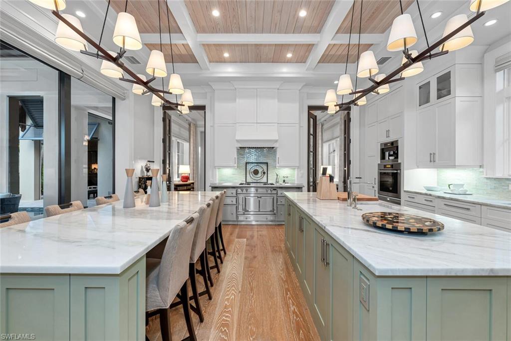 2284 Crayton Road Naples, FL 34103 - Photo 11 of 34 a kitchen with counter top space a sink cabinets and appliances