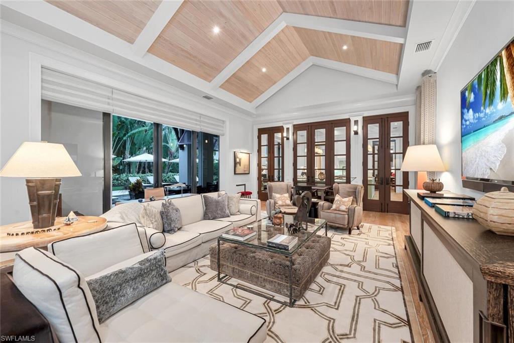 2284 Crayton Road Naples, FL 34103 - Photo 12 of 34 a living room with furniture and a large window