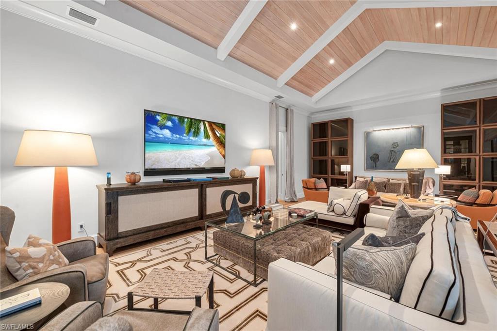 2284 Crayton Road Naples, FL 34103 - Photo 13 of 34 a living room with furniture and a flat screen tv