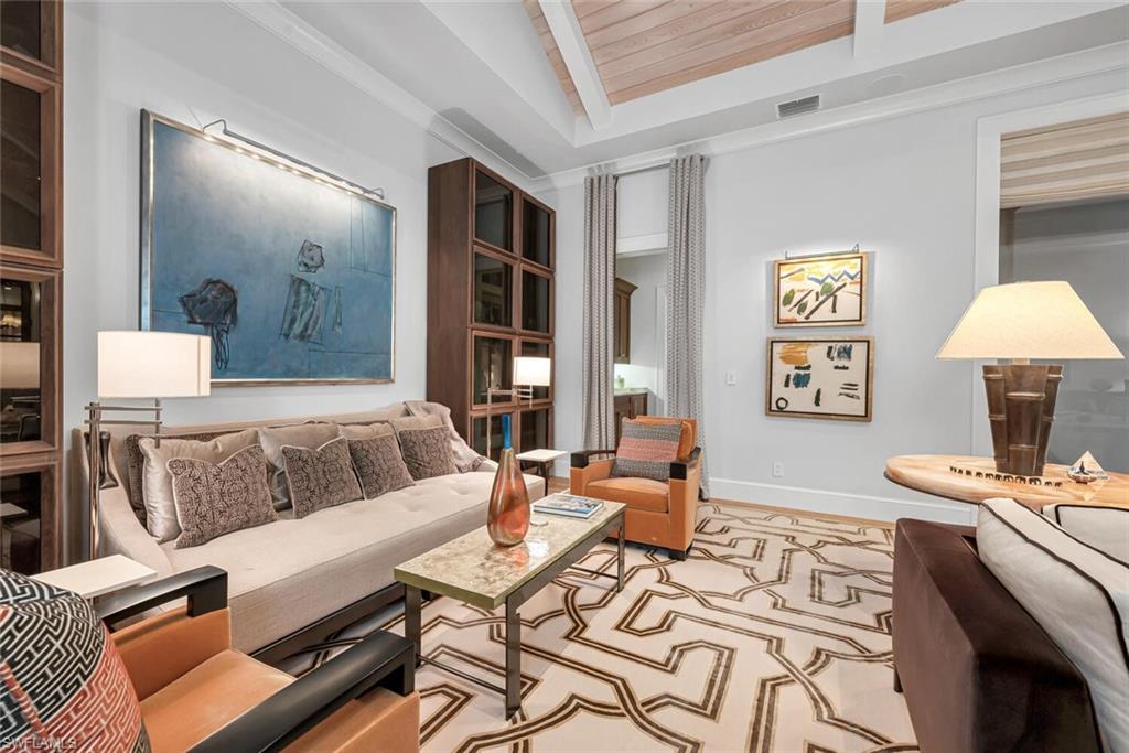 2284 Crayton Road Naples, FL 34103 - Photo 14 of 34 a living room with furniture and a table