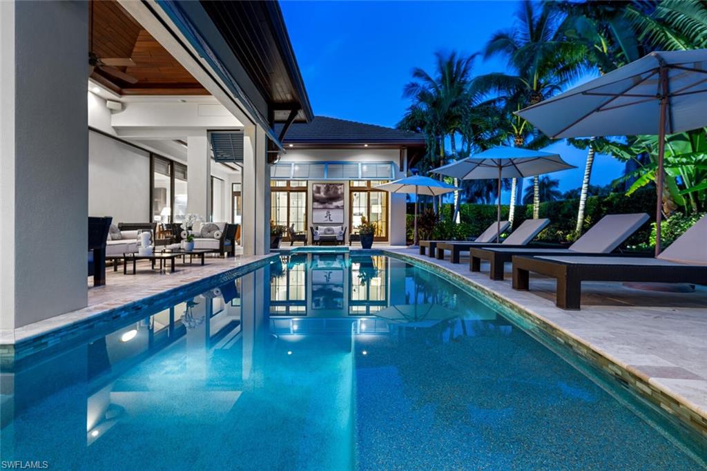 2284 Crayton Road Naples, FL 34103 - Photo 18 of 34 a view of a swimming pool with a patio