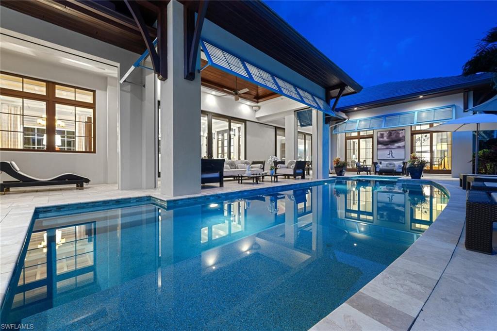 2284 Crayton Road Naples, FL 34103 - Photo 20 of 34 a hallway with dining table and chairs
