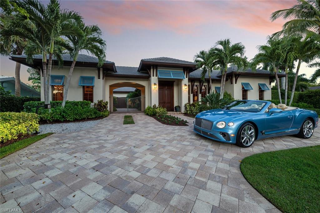 2284 Crayton Road Naples, FL 34103 - Photo 2 of 34 a view of a car parked in front of a brick house