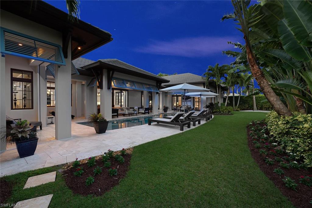 2284 Crayton Road Naples, FL 34103 - Photo 21 of 34 a view of a chair and tables in the patio