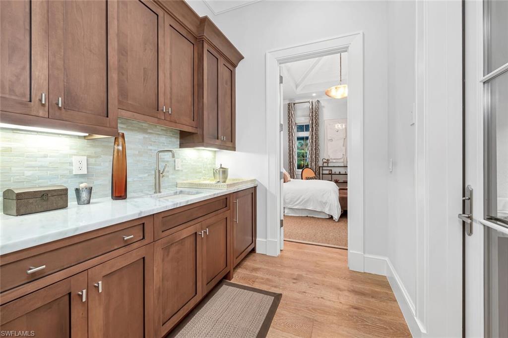 2284 Crayton Road Naples, FL 34103 - Photo 22 of 34 a en suite bathroom with a granite countertop sink and a mirror