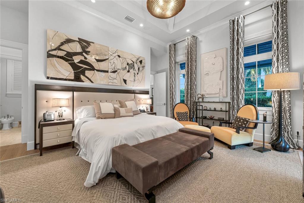 2284 Crayton Road Naples, FL 34103 - Photo 23 of 34 a bedroom with a bed and lamp