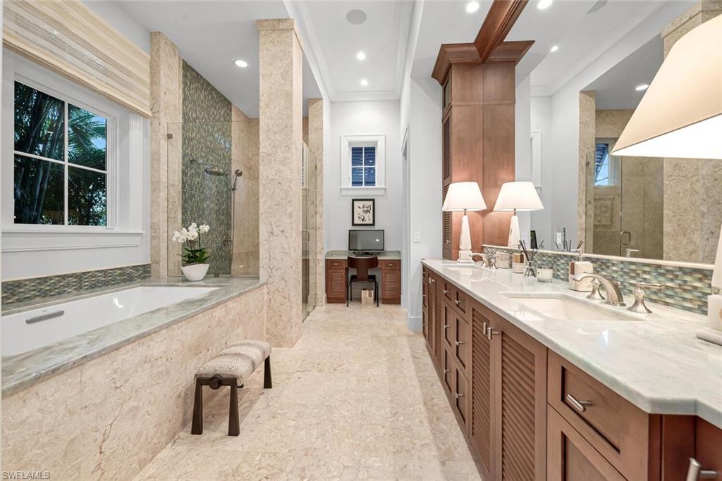 2284 Crayton Road Naples, FL 34103 - Photo 24 of 34 a bathroom with a granite countertop sink and a large mirror