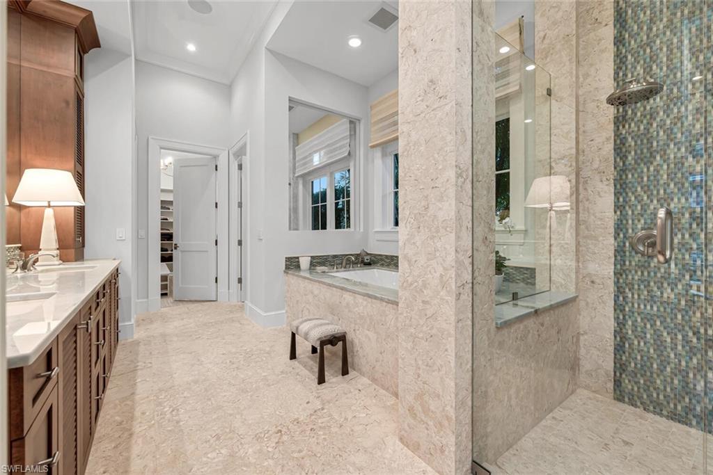 2284 Crayton Road Naples, FL 34103 - Photo 26 of 34 a bathroom with a granite countertop sink mirror and shower