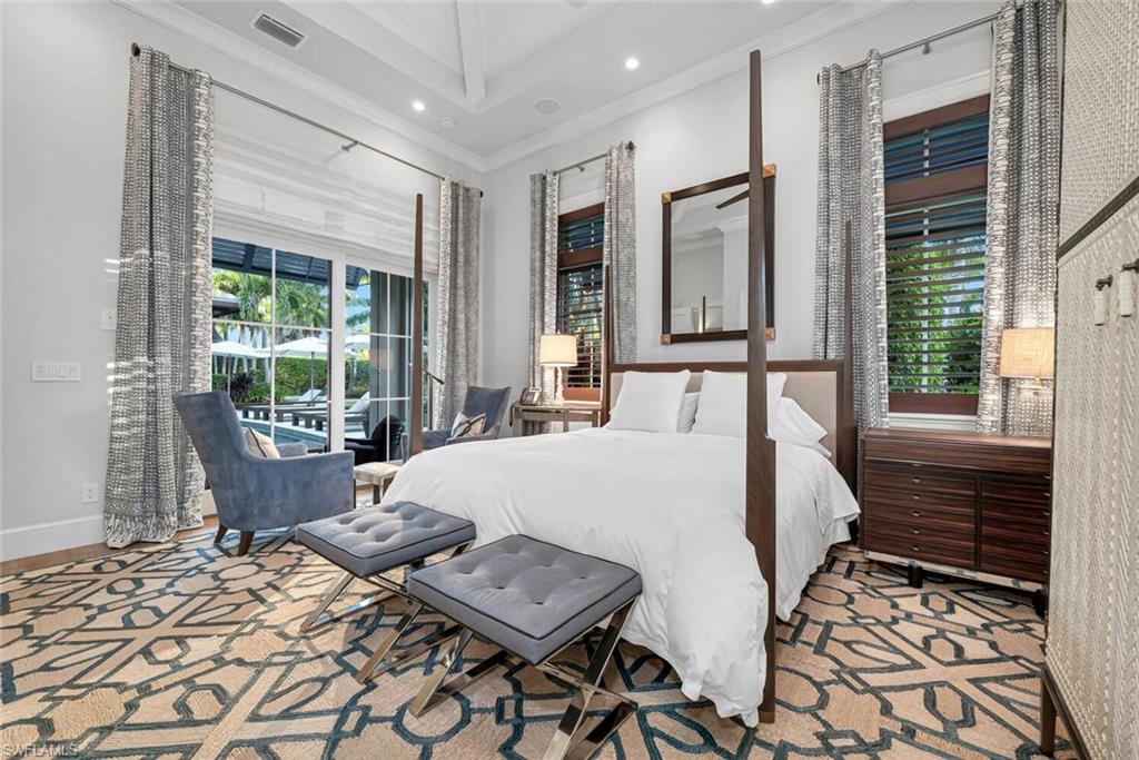 2284 Crayton Road Naples, FL 34103 - Photo 27 of 34 a bed sitting in a bedroom next to a window