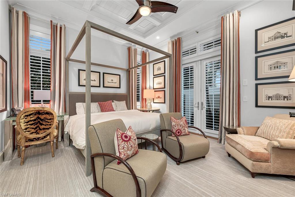 2284 Crayton Road Naples, FL 34103 - Photo 30 of 34 a bedroom with a bed and wooden floor