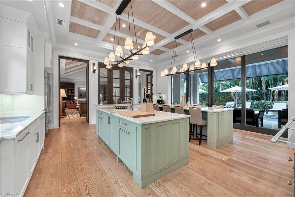 2284 Crayton Road Naples, FL 34103 - Photo 6 of 34 a kitchen with a sink and wooden floor