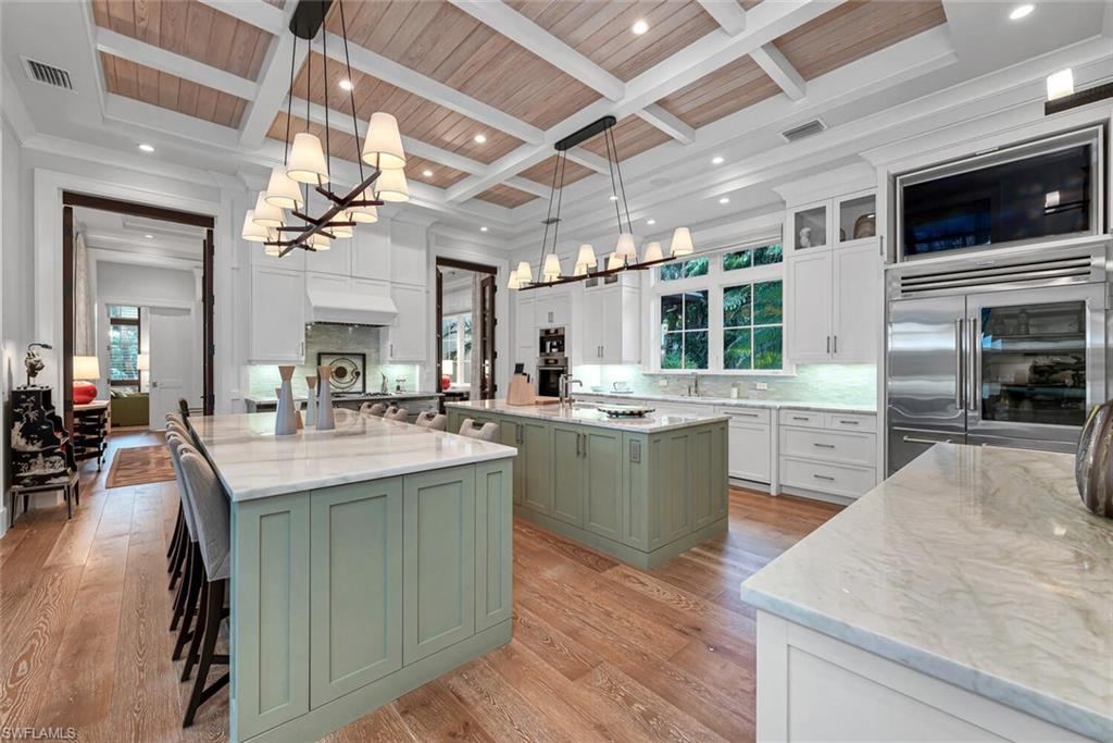 2284 Crayton Road Naples, FL 34103 - Photo 7 of 34 a kitchen with sink stove and cabinets