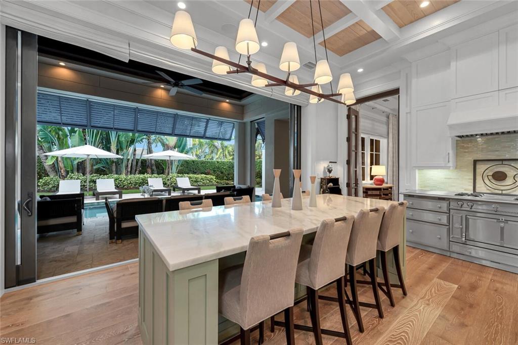 2284 Crayton Road Naples, FL 34103 - Photo 9 of 34 a large kitchen with a table and chairs