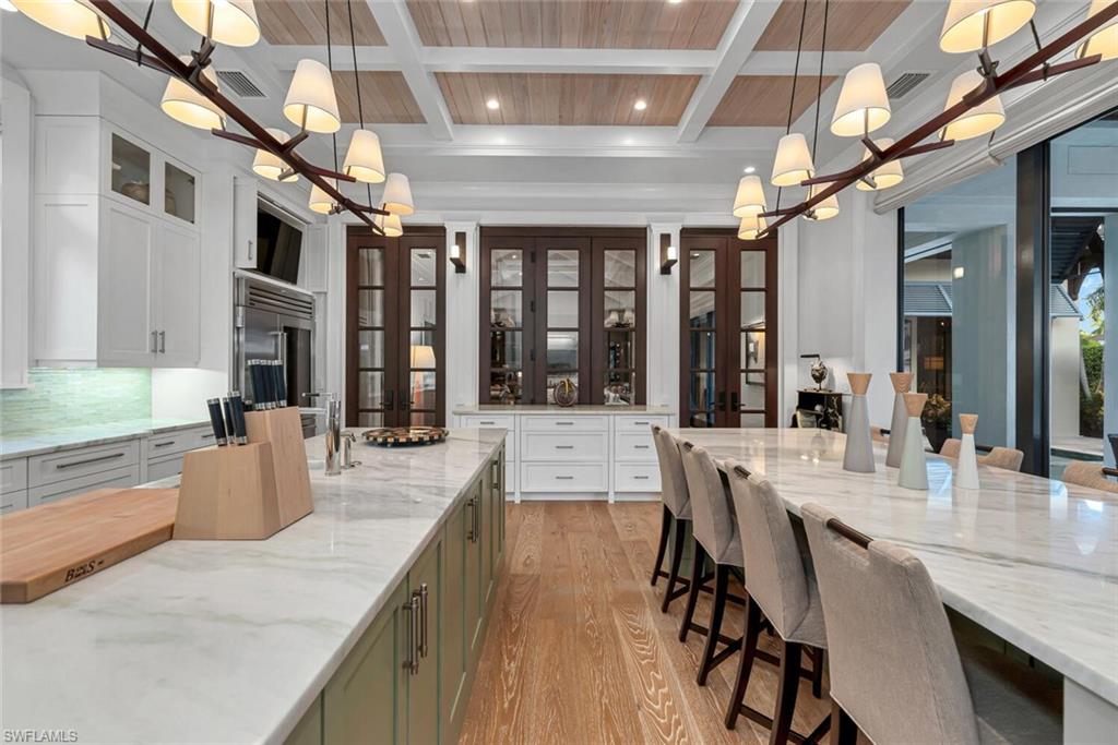 2284 Crayton Road Naples, FL 34103 - Photo 10 of 34 a dining hall with stainless steel appliances granite countertop a stove and cabinets