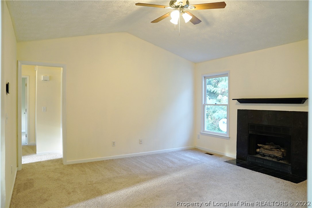 2029 Ashton Road Fayetteville, NC 28304 - Photo 12 of 37 an empty room with windows and fireplace