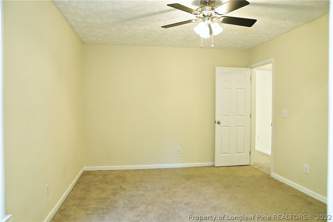 2029 Ashton Road Fayetteville, NC 28304 - Photo 18 of 37 an empty room with a ceiling fan and a window