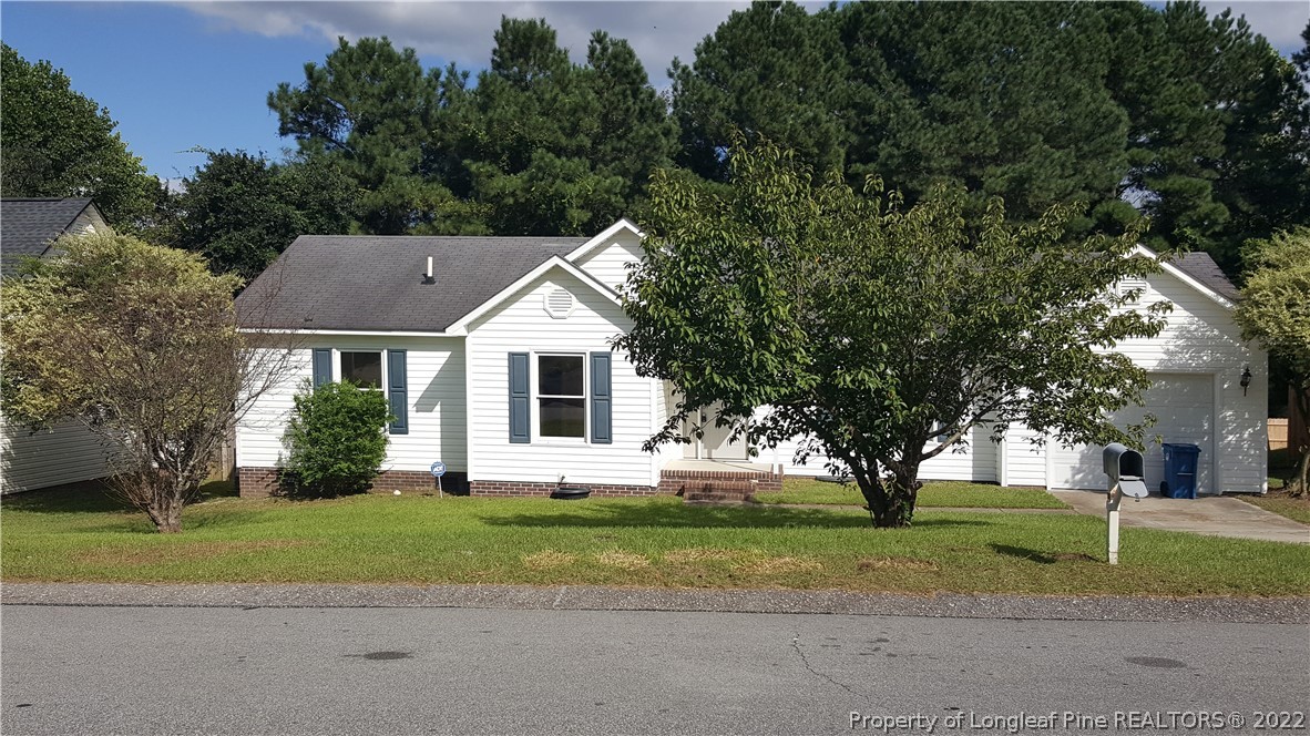 2029 Ashton Road Fayetteville, NC 28304 - Photo 2 of 37 a front view of a house with a yard and garage