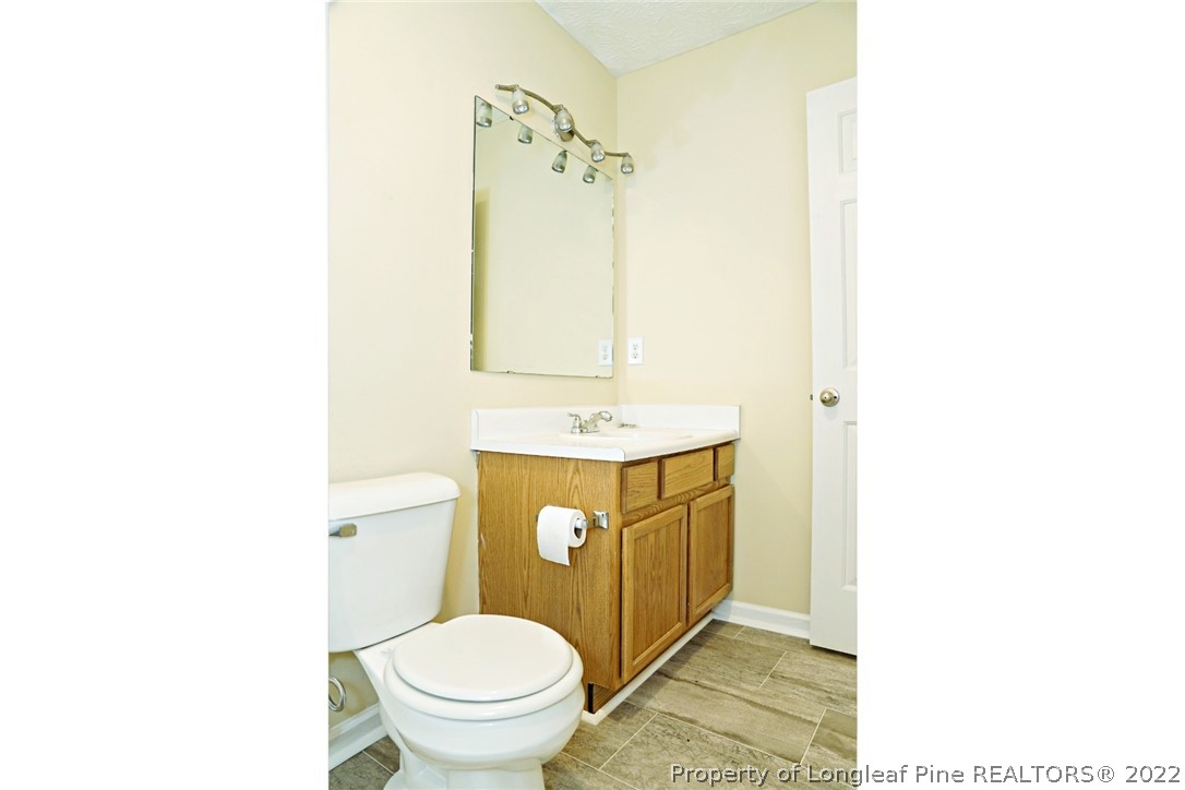 2029 Ashton Road Fayetteville, NC 28304 - Photo 23 of 37 a bathroom with a sink a toilet and a mirror