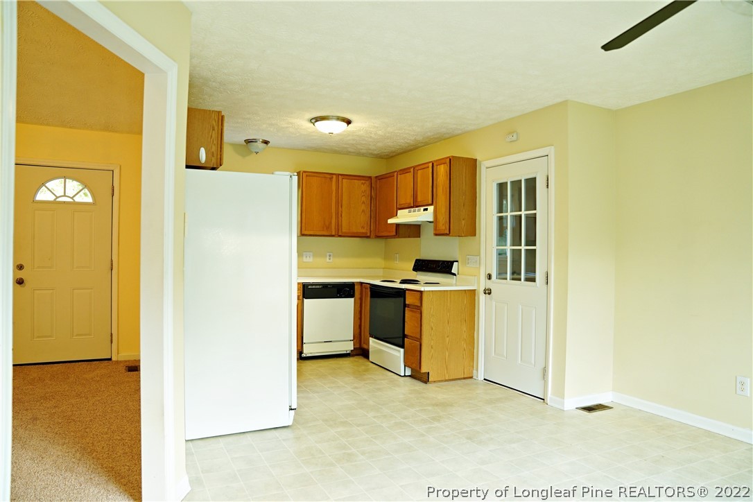 2029 Ashton Road Fayetteville, NC 28304 - Photo 36 of 37 a kitchen with a refrigerator and cabinets