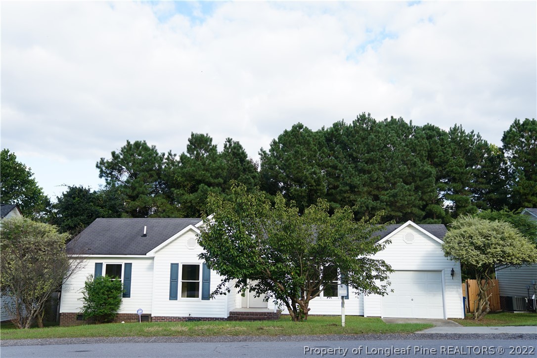 2029 Ashton Road Fayetteville, NC 28304 - Photo 5 of 37 a front view of a house with a yard and garage
