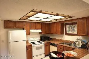 a kitchen with a refrigerator and a stove top oven