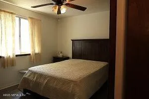 a bed sitting in a bedroom next to a window