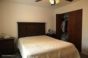 a bedroom with a bed and a closet