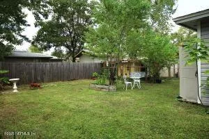 a view of a table and chairs in the garden