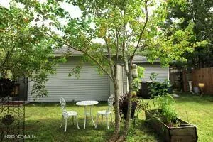 a backyard of a house with yard and outdoor seating
