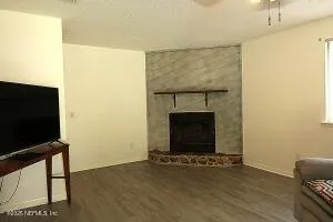 a living room with a fireplace and a flat screen tv