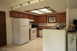 a kitchen with a refrigerator and a stove