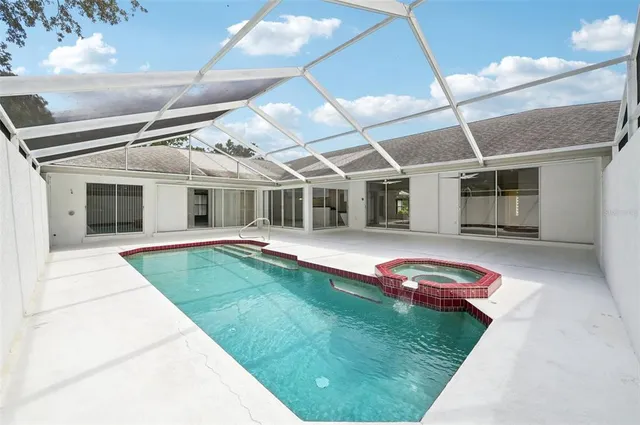 a view of a white house with a swimming pool