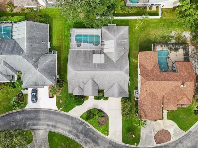 an aerial view of a house with garden space and street view