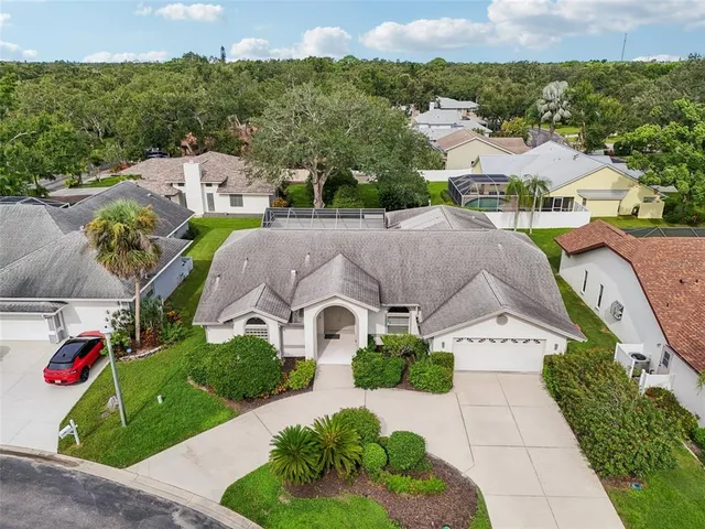 an aerial view of multiple houses with a yard