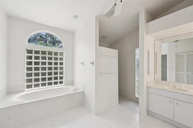 a spacious bathroom with a bathtub and a shower