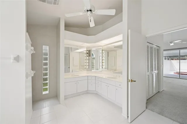 a bathroom with a granite countertop sink and shower