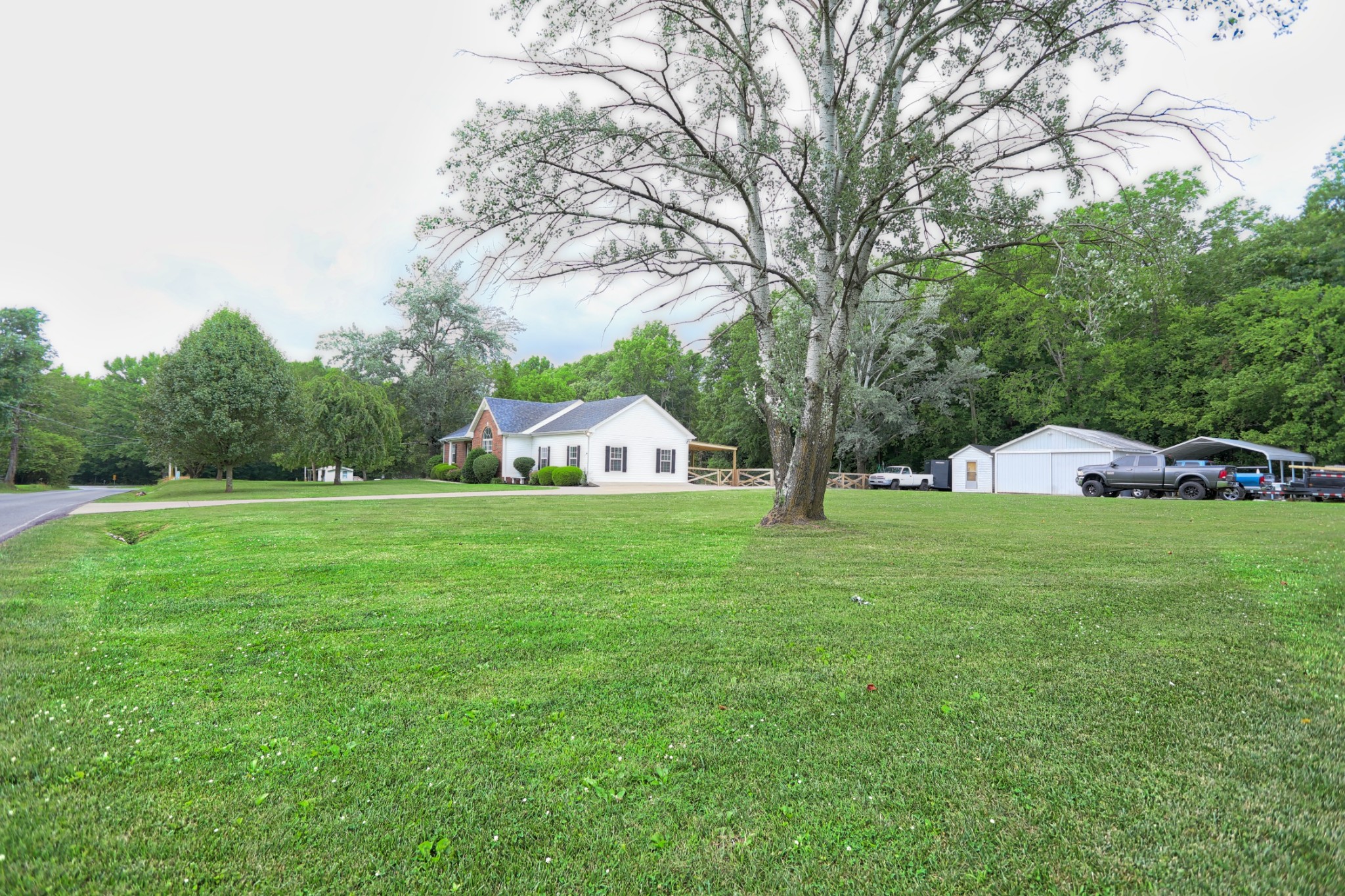 153 Clearview Road Cottontown, TN 37048 - Photo 8 of 39 a view of a trees and barn in the middle of a yard
