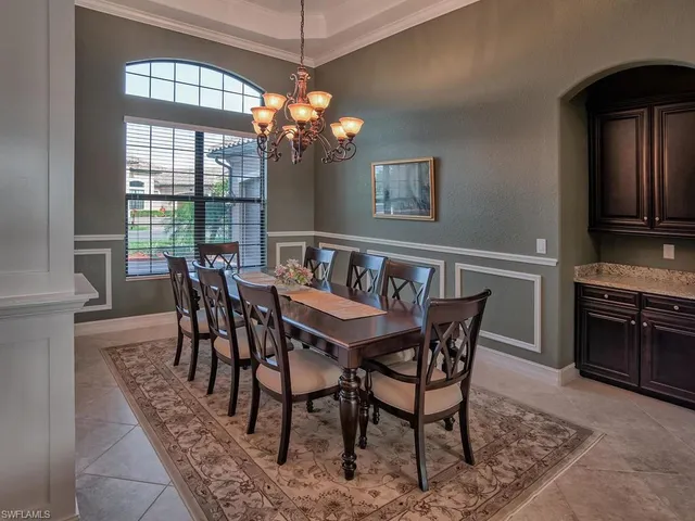 a view of a dining room with furniture wooden floor and chandelier