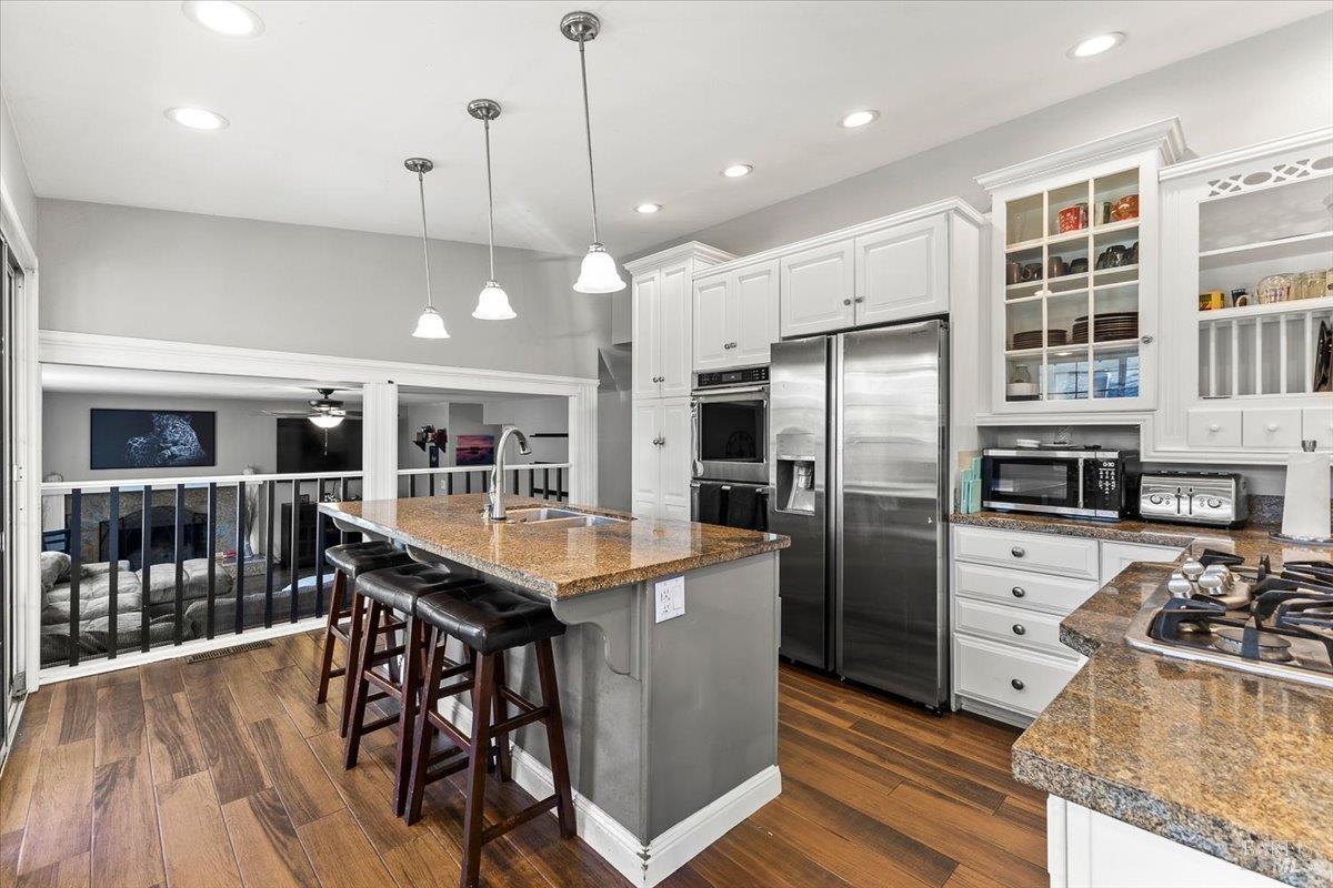 4457 Graywhaler Lane Rohnert Park, CA 94928 - Photo 12 of 51 a kitchen with stainless steel appliances granite countertop a table chairs stove and refrigerator