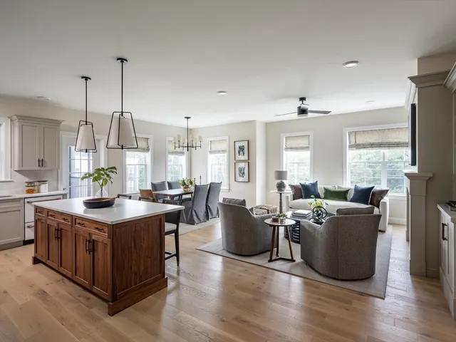 a living room with furniture a wooden floor and a chandelier