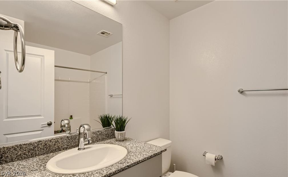 12110 Midnight Pine Road, Unit 3 Las Vegas, NV 89183 - Photo 7 of 13 A well-appointed bathroom features a sleek vanity with a spacious basin, enhancing daily routines.
